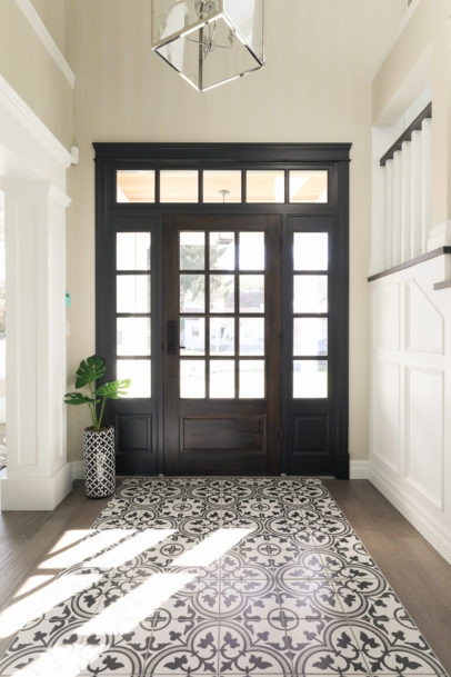 Foyer with full glass custom wood front door in home plan by Hollie Whitehead